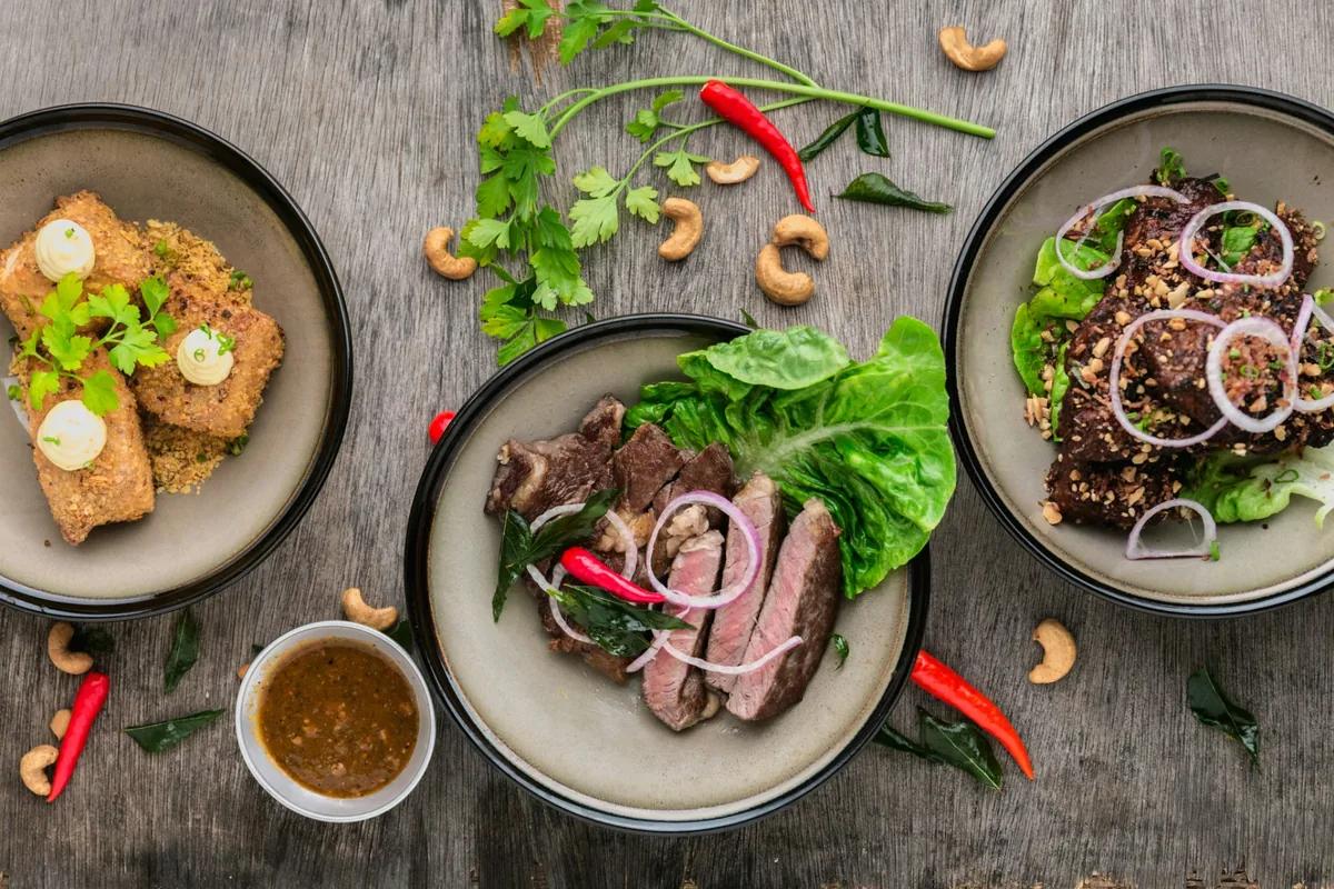 Balanced meal bowls on a wooden table with herbs and chili